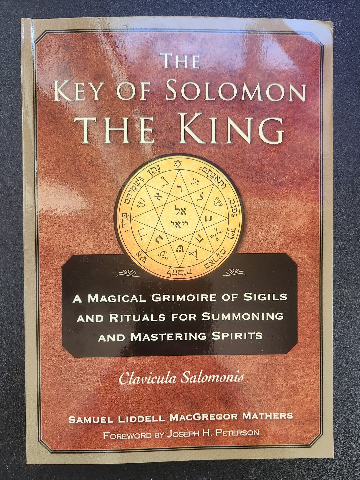 Book cover of 'The Key of Solomon the King' with a red and gold design.