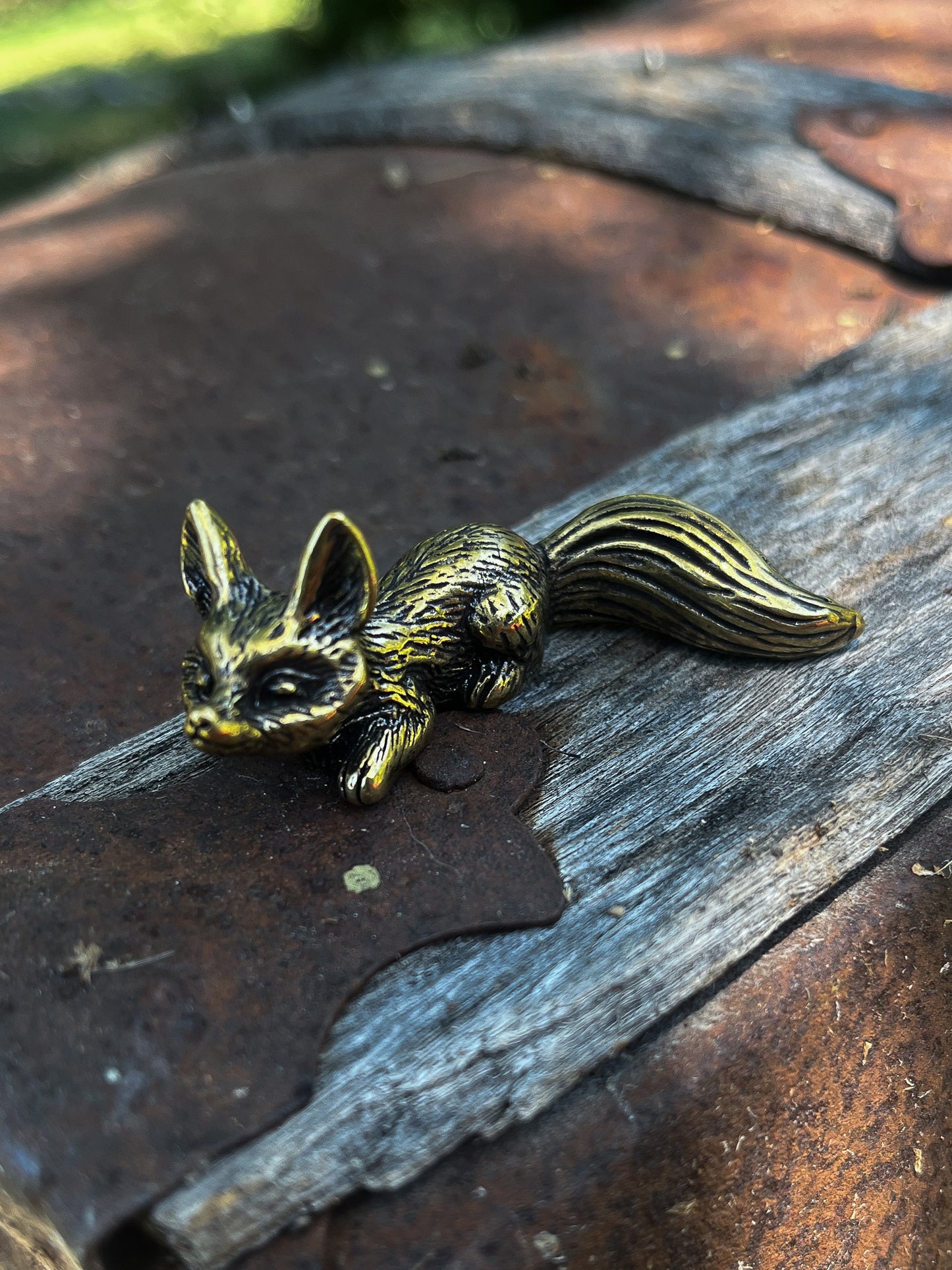 Brass Fox Laying Down